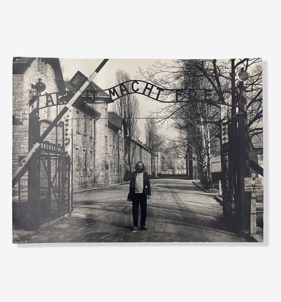 Photograph of Allen Ginsberg at the gates of Auschwitz