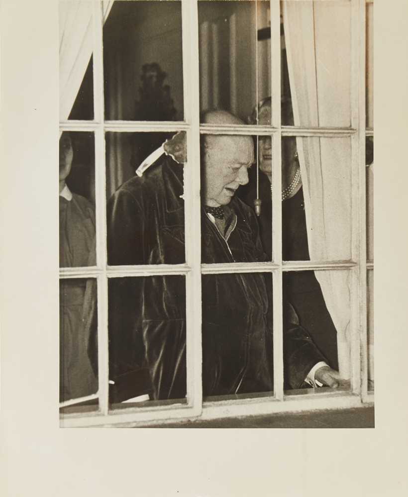 Photograph of Sir Winston Churchill at window of his London home