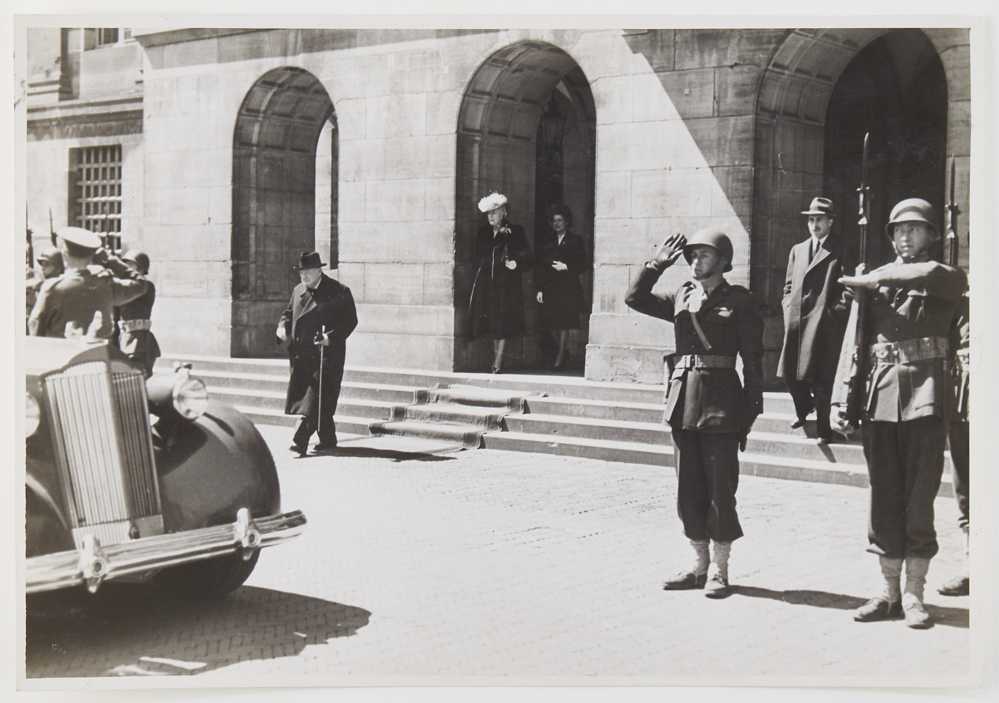 Photograph of Winston Churchill approaching a car