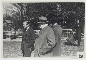Photograph of Winston Churchill and three other men in field