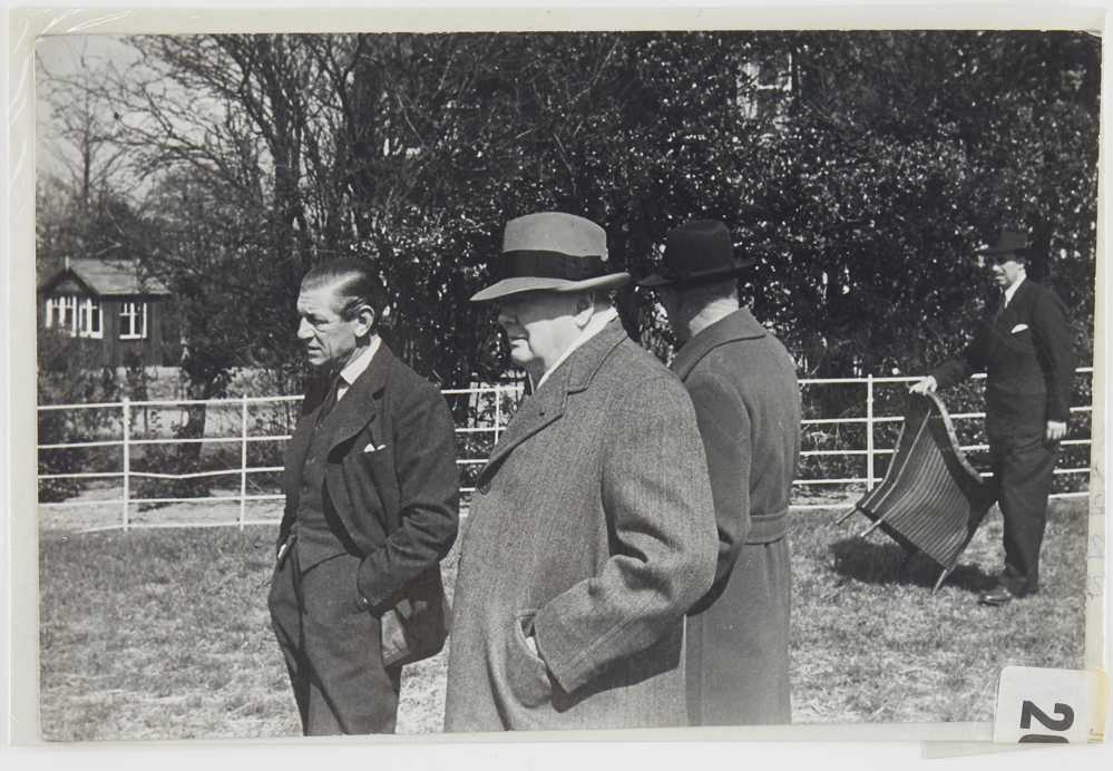 Photograph of Winston Churchill and three other men in field
